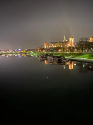 a view of a river at night with a city at AMETYST Apartment in Kraków