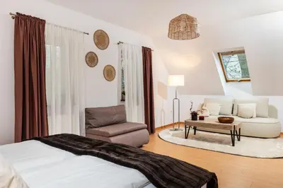 a bedroom with a bed and a couch and a chair at Your private oasis in Cracow in Kraków