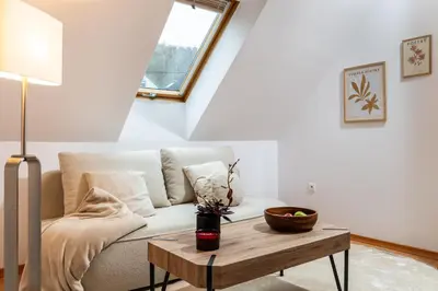 a living room with a couch and a table at Your private oasis in Cracow in Kraków