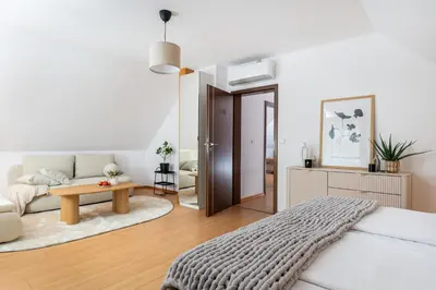 a bedroom with a bed and a living room at Your private oasis in Cracow in Kraków