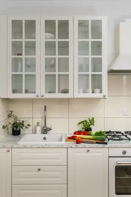 a white kitchen with white cabinets and a sink at Your private oasis in Cracow in Kraków