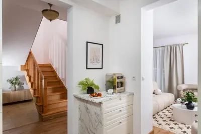 a living room with white walls and a staircase at Your private oasis in Cracow in Kraków