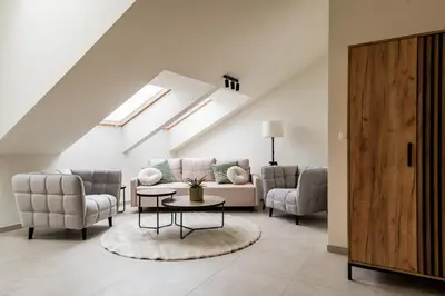 a living room with a couch and chairs and a table at Apartament Park Zdrojowy 11 - NOWOŚĆ in Rabka