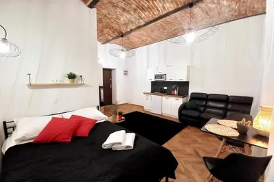 a bedroom with a large bed with red pillows at Old Town Apartment Lubicz Street L2a in Kraków
