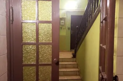 a hallway with a door and a staircase with a stair case at Old Town Apartment Lubicz Street L2a in Kraków