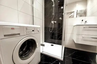 a white washer and dryer in a bathroom at Old Town Apartment Lubicz Street L2a in Kraków