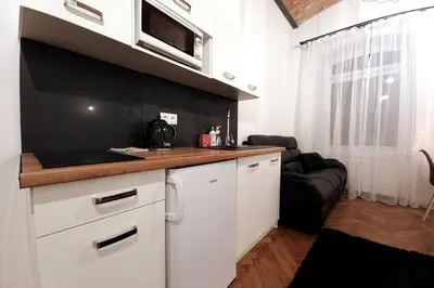 a kitchen with white cabinets and a counter top at Old Town Apartment Lubicz Street L2a in Kraków