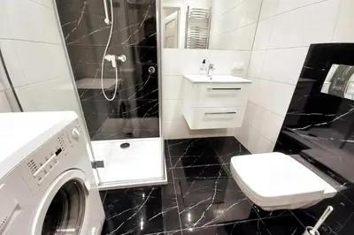 a bathroom with a washing machine and a sink at Old Town Apartment Lubicz Street L2a in Kraków