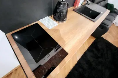 a wooden table with a vase on top of it at Old Town Apartment Lubicz Street L2a in Kraków