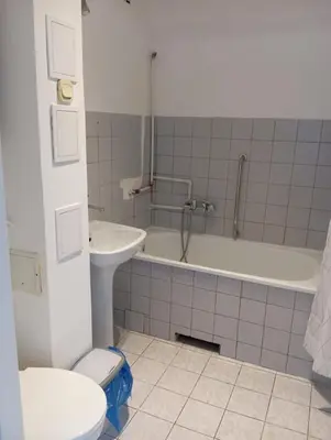 a bathroom with a tub and a toilet and a sink at Królewska in Kraków