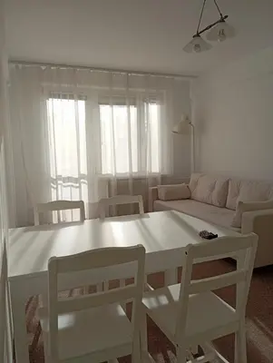 a living room with a white table and chairs at Królewska in Kraków