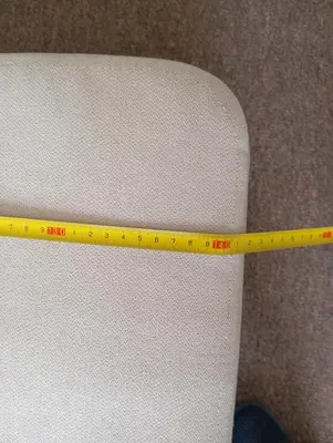 a yellow ruler sitting on top of a white chair at Królewska in Kraków