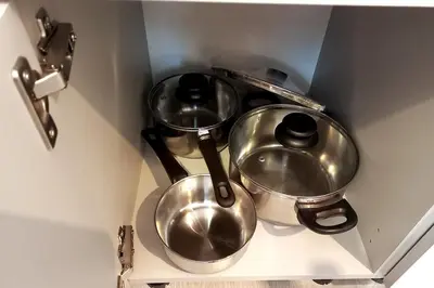 three metal pots on a shelf in a kitchen at Stary Krakow - Sołtyka S2a in Kraków