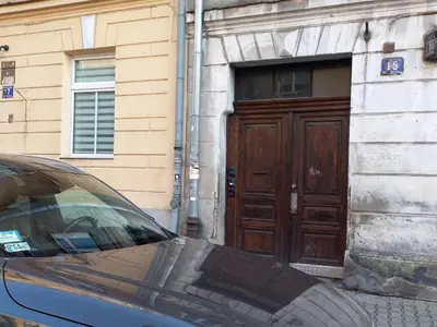 a car parked in front of a building with a wooden door at Stary Krakow - Sołtyka S2a in Kraków