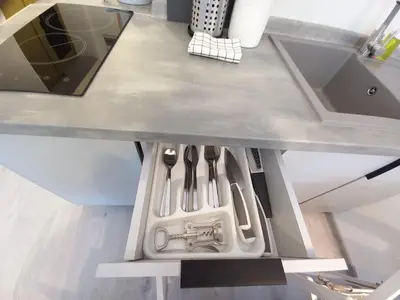 a kitchen with an open drawer with utensils at Stary Krakow - Sołtyka S2a in Kraków