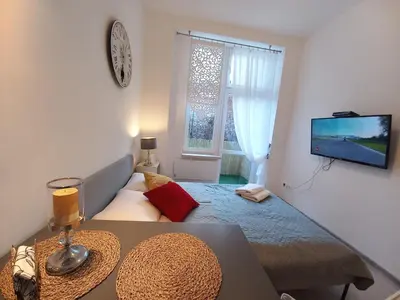 a small living room with a couch and a television at Stary Krakow - Sołtyka S2a in Kraków