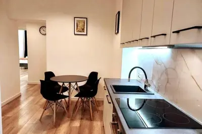 a kitchen with a table and chairs and a counter at Apartment by Wawel castel - G1a in Kraków