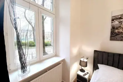 a bedroom with a window and a bed and a lamp at Apartment by Wawel castel - G1a in Kraków