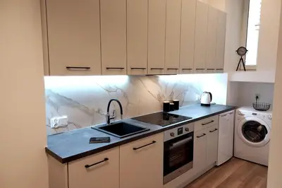 a kitchen with a sink and a washing machine at Apartment by Wawel castel - G1a in Kraków