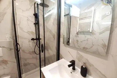 a bathroom with a shower and a sink and a mirror at Apartment by Wawel castel - G1a in Kraków