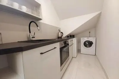 a white kitchen with a sink and a washing machine at Cozy apartment by Wawel castel - G1b in Kraków