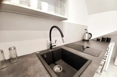 a kitchen with a sink in a kitchen at Cozy apartment by Wawel castel - G1b in Kraków