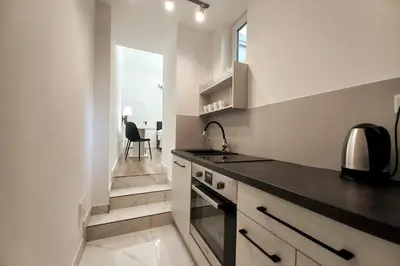 a kitchen with a sink and a stove top oven at Cozy apartment by Wawel castel - G1b in Kraków