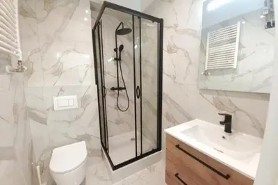 a bathroom with a shower and a toilet and a sink at Cozy apartment by Wawel castel - G1b in Kraków