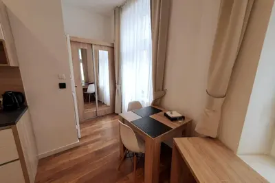 a small room with a table and a window at Bosacka - old town cozy apartment B16 in Kraków