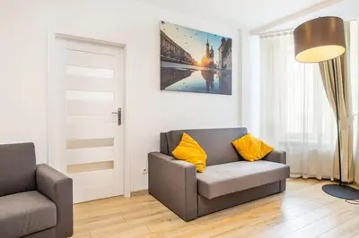 a living room with a couch and a chair at Bosacka old town apt - B17 in Kraków