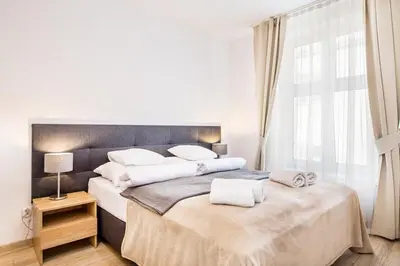 a bedroom with two beds with white towels on them at Bosacka old town apt - B17 in Kraków