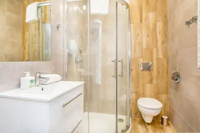 a bathroom with a shower and a toilet and a sink at Bosacka old town apartment - B28 in Kraków