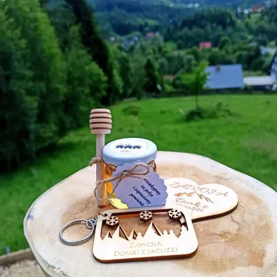 a jar of honey sitting on top of a table at Zawoja domki z jacuzzi, domek w stylu góralskim in Zawoja