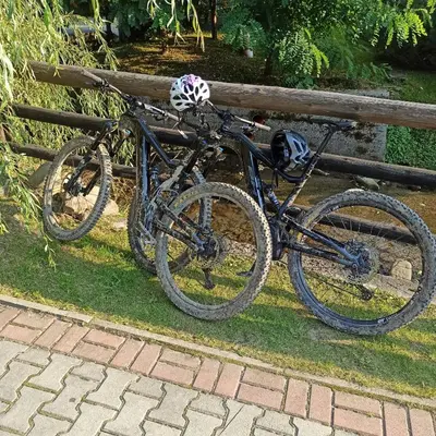 a bike is parked next to a fence at Zawoja domki z jacuzzi, domek w stylu góralskim in Zawoja