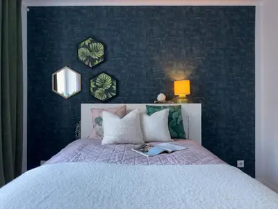 a bedroom with a bed with a book on it at Apartament nieopodal Centrum Nauki Cogiteon in Kraków