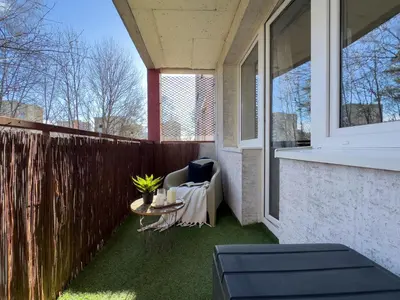 a patio with a table and a chair on a balcony at Apartament nieopodal Centrum Nauki Cogiteon in Kraków