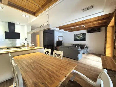 a kitchen and living room with a table and a couch at Forest House- dom nad górskim potokiem in Juszczyn