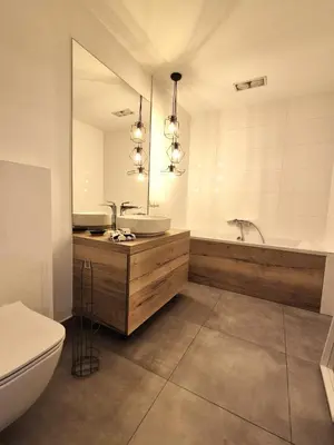 a bathroom with a sink and a tub and a toilet at Forest House- dom nad górskim potokiem in Juszczyn