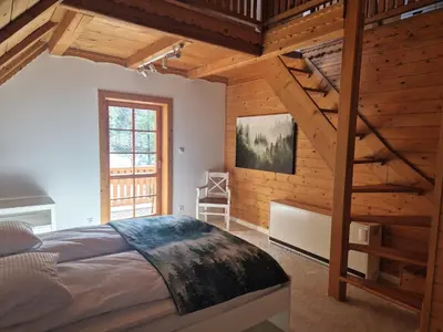 a bedroom with a loft bed and a ladder at Forest House- dom nad górskim potokiem in Juszczyn