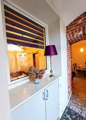 a lamp sitting on a counter in a room with a window at Vintage Lubicz Apartment in Kraków