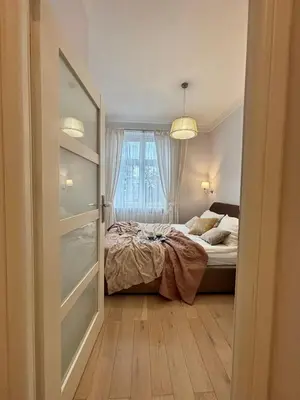 a bedroom with a bed and a window at Vintage Lubicz Apartment in Kraków