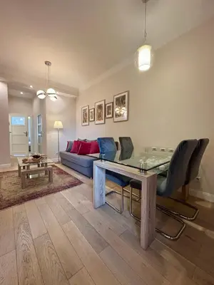 a living room with a table and a couch at Vintage Lubicz Apartment in Kraków