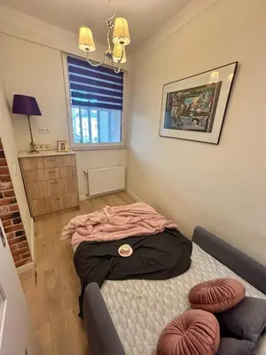 a bedroom with a bed in a room with a window at Vintage Lubicz Apartment in Kraków
