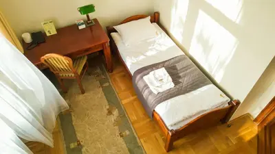 an overhead view of a bedroom with a bed and a desk at Dom rekolekcyjny Vincentinum in Krzeszowice