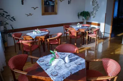 a dining room with tables and red chairs at Dom rekolekcyjny Vincentinum in Krzeszowice