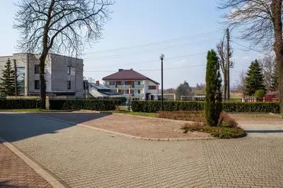 a brick walkway in front of a house and a building at Dom rekolekcyjny Vincentinum in Krzeszowice