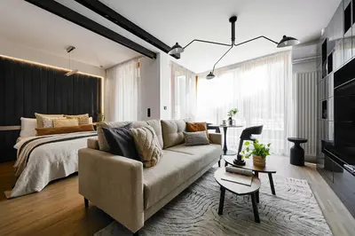 a living room with a couch and a bed at Kazimierz Comfort Flat in Kraków