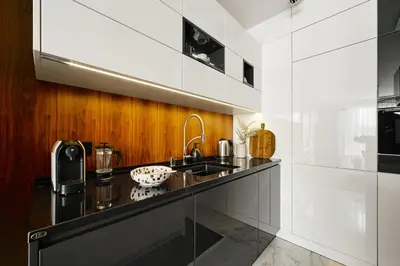 a kitchen with a sink and a counter at Kazimierz Comfort Flat in Kraków