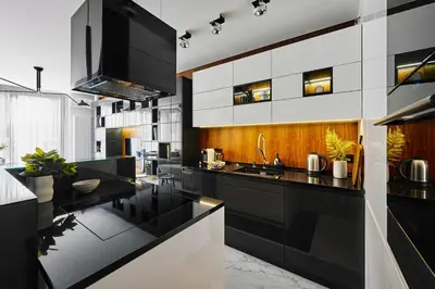 a kitchen with black and white counters and a sink at Kazimierz Comfort Flat in Kraków