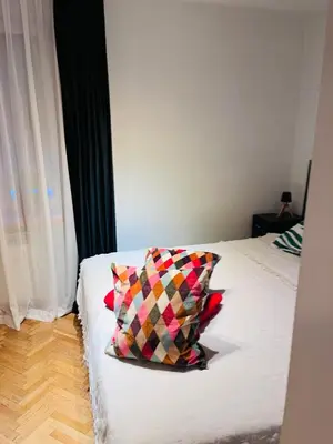 a bedroom with a bed with a pillow on it at Biały Lotos in Kraków